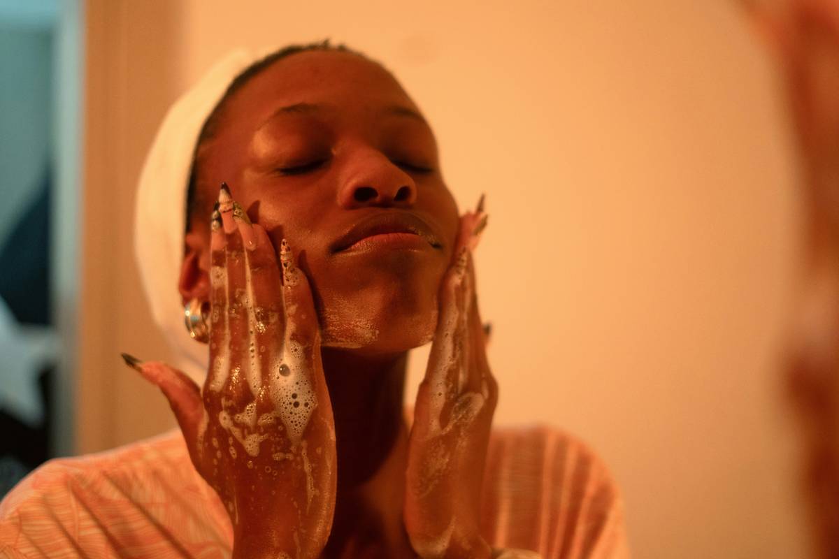Close-up of smooth feet after using a foot scrub with text overlay: is body scrub good for skin